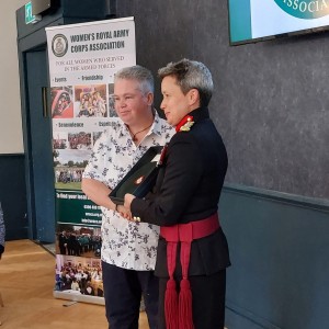 The restoration of the beret and cap badge to Lu Tait by Brigadier Clare Philips CBE at the WRACA AGM Scotland and Northern Ireland